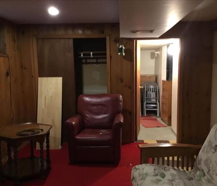  Basement with furnishings and hallway with red rug